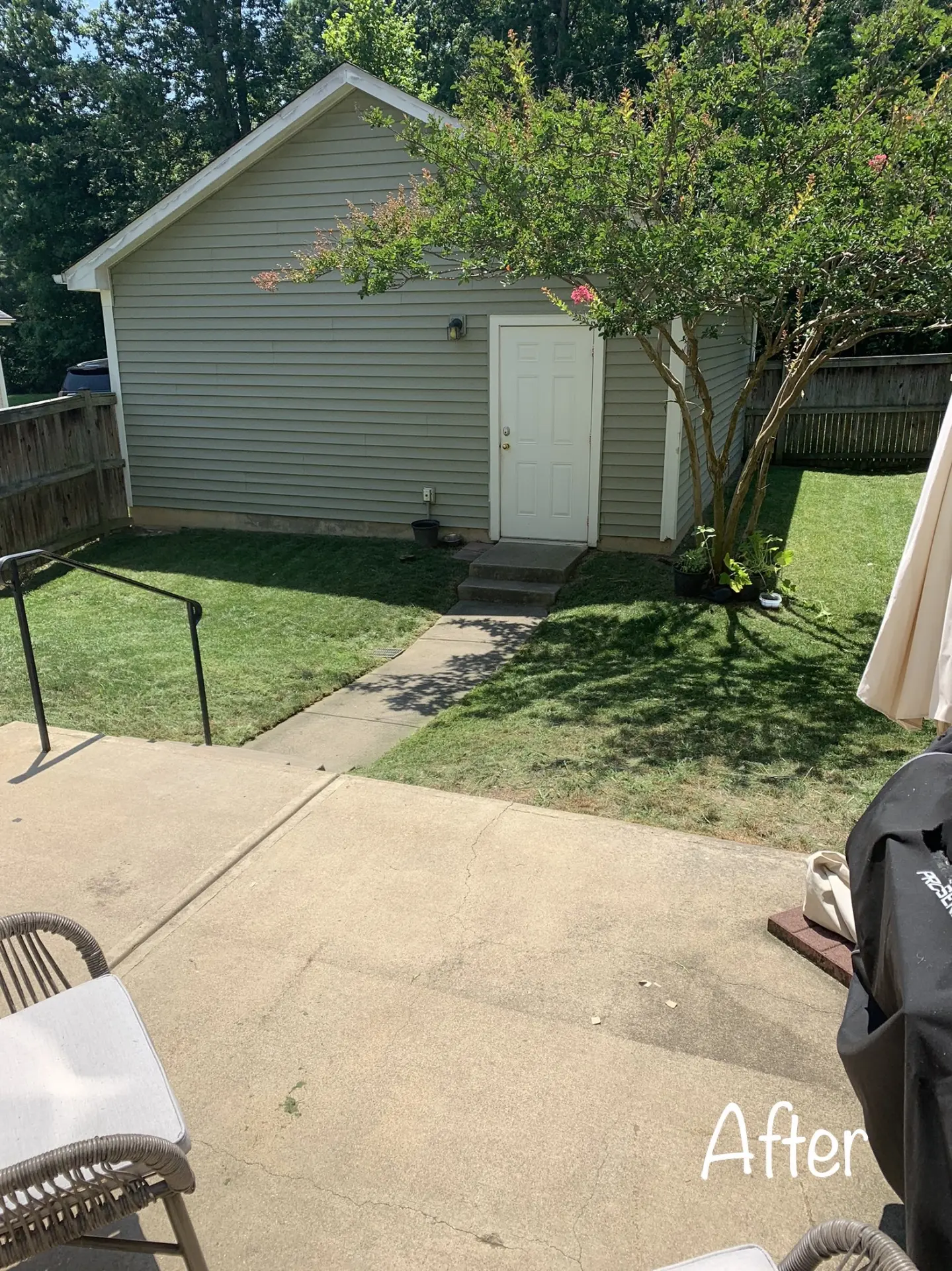 Tidy lawn and swept patio after a completed yard service